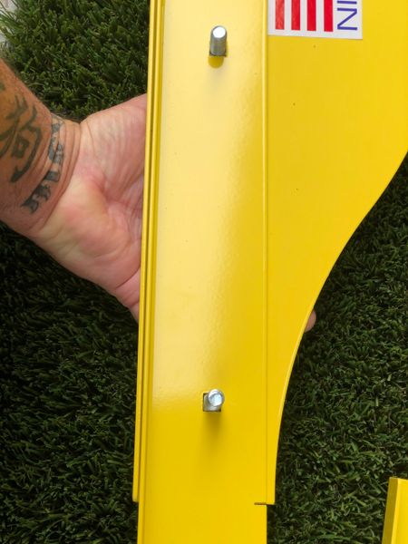A person holding onto the side of a yellow object.