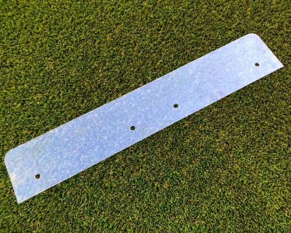 A metal strip that is sitting on the grass.